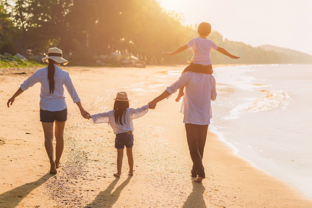 Prestige Wealth Partners - happy family walking at the beach